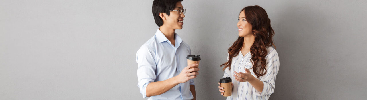 Coworkers talking drinking coffee