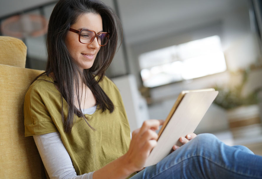 Woman sitting on floor looking at laptop