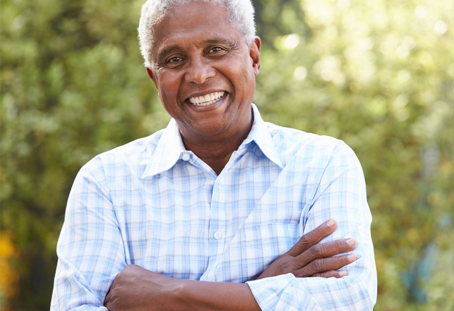 Man smiling with arms crossed