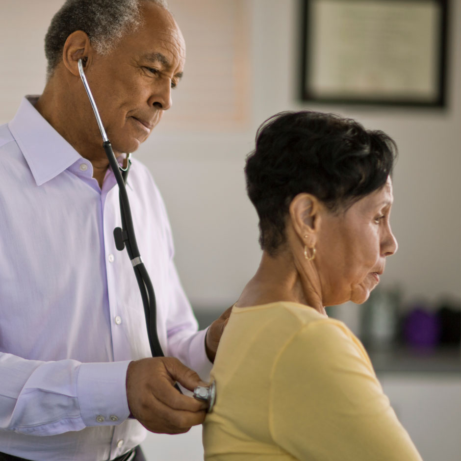 Doctor checking patients breathing