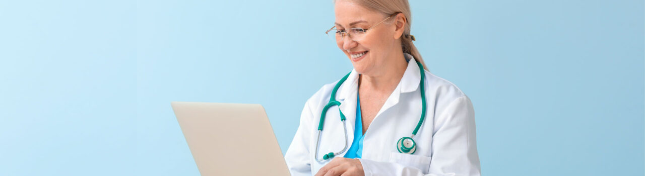 Female doctor looking at laptop