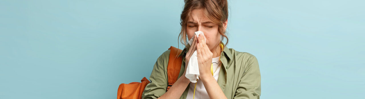 Woman blowing her nose