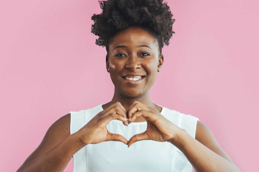 Woman showing love by making a heart with her hands