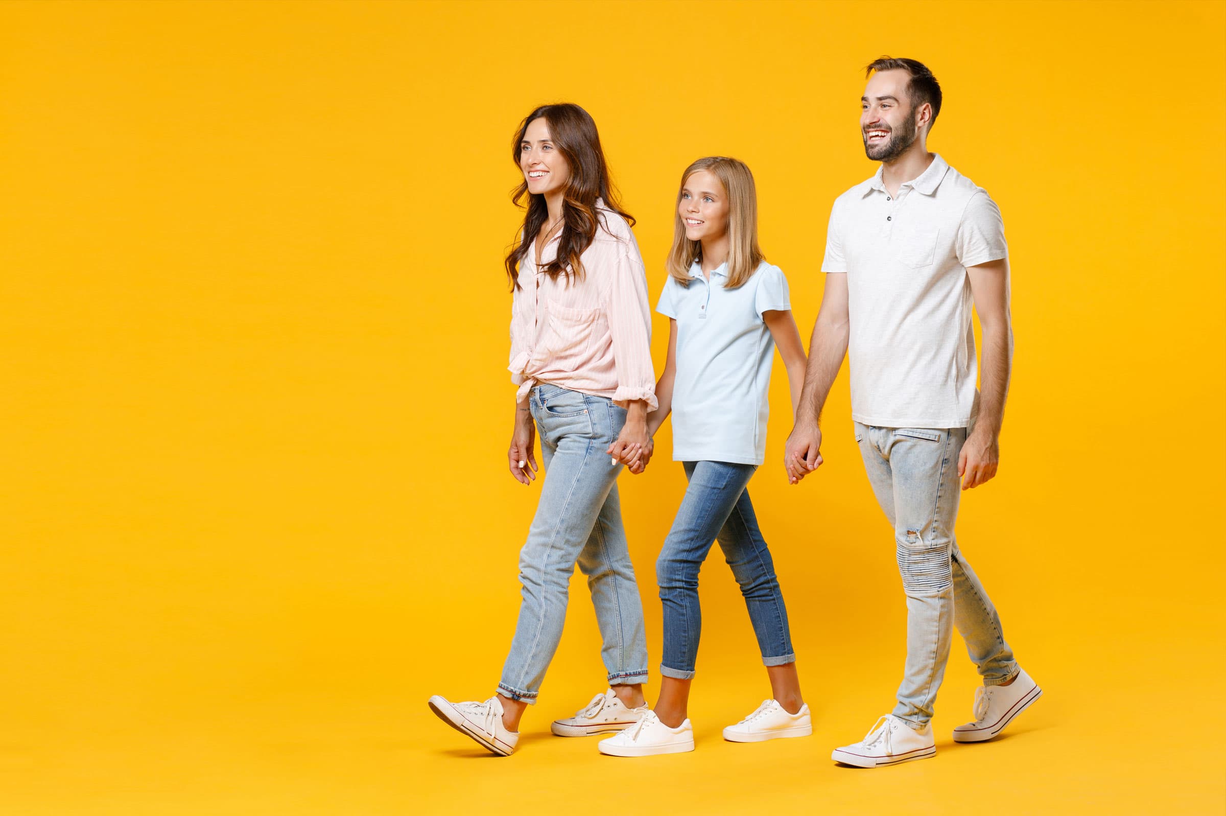 Mother father and daughter walking together as a family