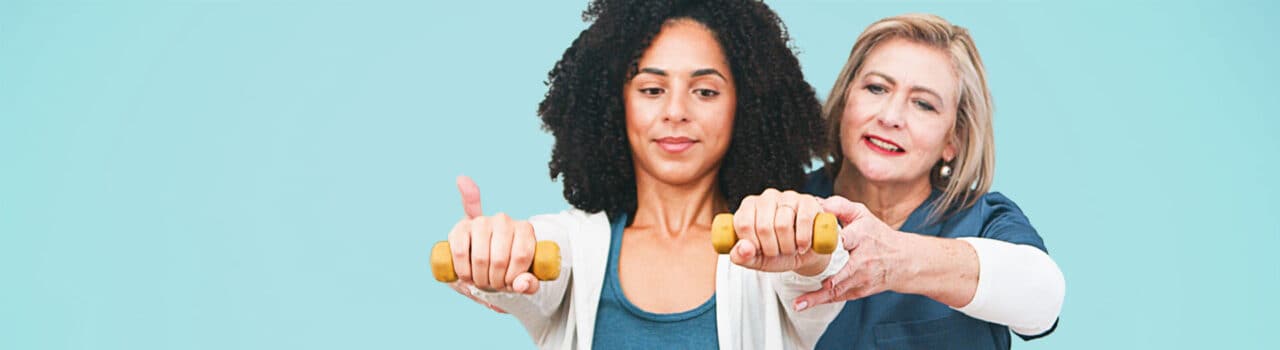 Physical Therapist helping patient lift weights